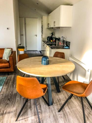 a kitchen and dining room with a table and chairs at Beachhouse in Hulshorst