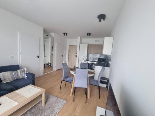 a living room and kitchen with a table and chairs at Apartments in - Świergotki in Szczecin
