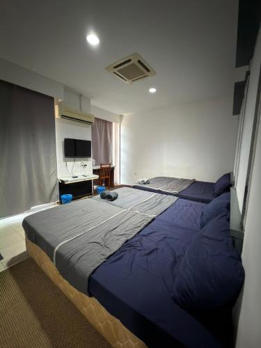 a bedroom with a large blue bed in a room at MyPlace Sri Cemerlang Kota Bharu in Kota Bharu