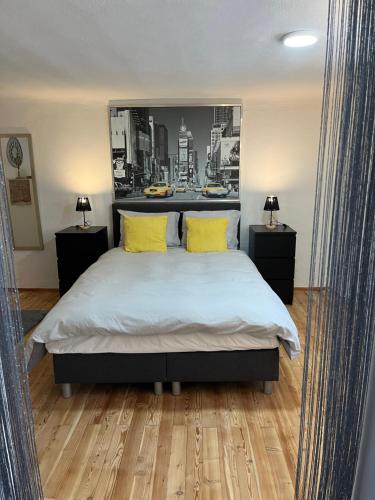 a bedroom with a large bed with yellow pillows at Haus Almblick in Gasen