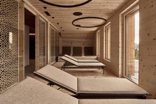 a room with benches and windows in a building at The Suites in St. Moritz