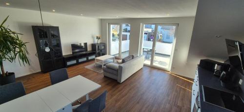 a living room with a couch and a table at Neckartalblick in Nürtingen
