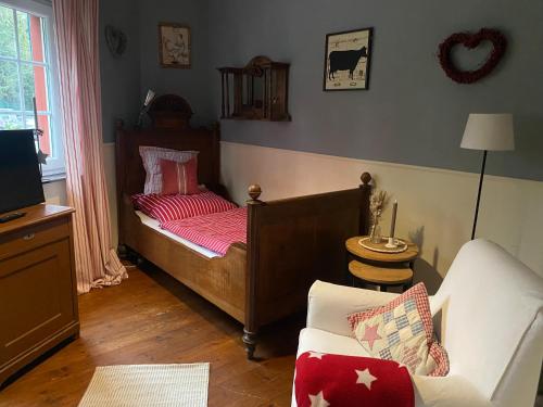 a bedroom with a bed and a couch at Stern in Bergheim