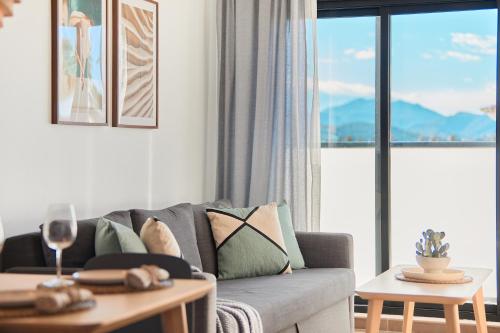 a living room with a couch and a table at Las Dunas 215 - by Welcomely in Oliva