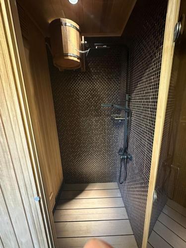 a shower stall in a bathroom with a shower at Cheerful 3-bedroom villa with pool in Oganavan