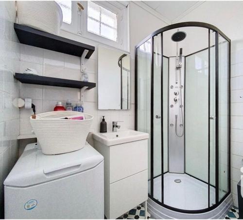 a small bathroom with a shower and a sink at Exceptional beach sea view in Plestin-les-Grèves
