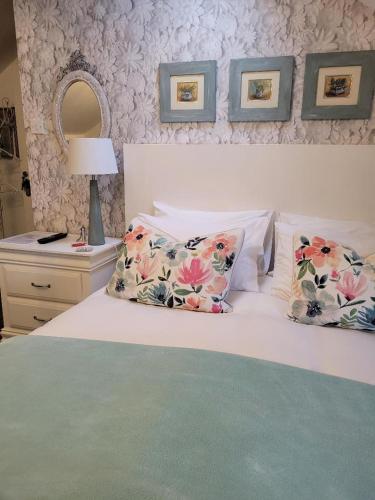 a bedroom with a bed with two pillows and a mirror at The Bridges B&B in Broomhill