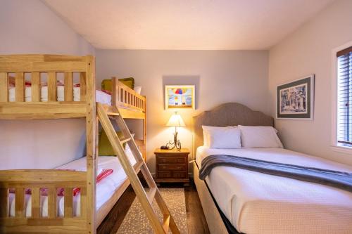 a bedroom with two bunk beds and a ladder at Chetola: Robin 1 in Blowing Rock
