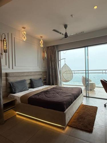 a bedroom with a large bed and a large window at Spira staycation in New Delhi