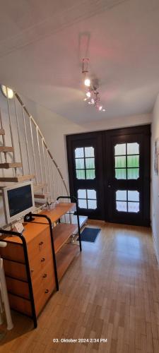 a room with a staircase and a desk with a computer at Studio Wille in Lünen