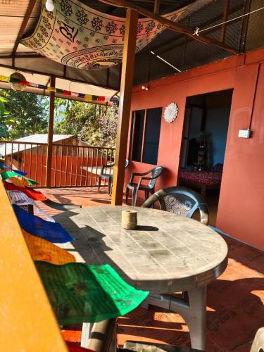a table and chairs on a patio at Nuwakot Hills Farmstay in Trisūli Bāzār