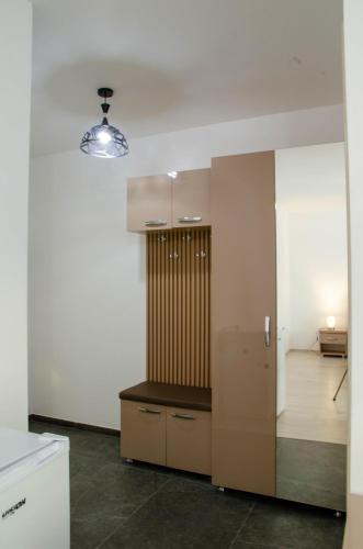 a kitchen with a refrigerator and a living room at Casa Georgia in Târgu Ocna