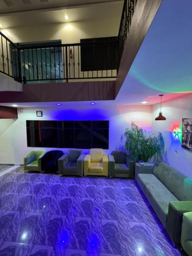 a living room with purple lighting in a house at Ja'oak Hotel and Suite in Mama