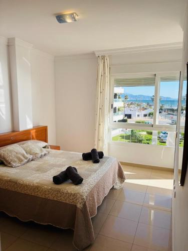 a bedroom with a bed and a large window at Apartamento PLAYANALA in Torrox Costa