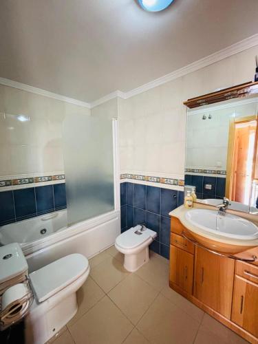 a bathroom with a sink and a toilet and a tub and a sink at Apartamento PLAYANALA in Torrox Costa