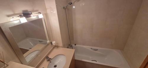a bathroom with a tub and a toilet and a sink at Casa Londi in Almuñécar