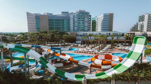a pool with a water slide at a resort at Sherwood Exclusive Lara in Lara