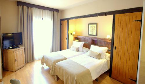 Ένα ή περισσότερα κρεβάτια σε δωμάτιο στο Hotel Kenia Nevada