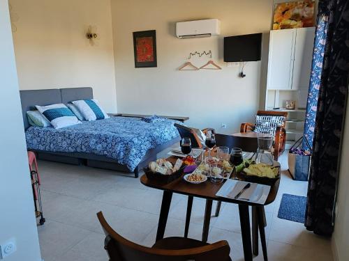 a room with a bed and a table with food on it at Gite avec piscine in Crespian