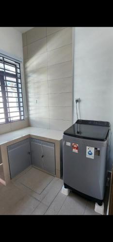 a room with a tank in the corner of a room at Spacious 4 bedroom homestay in Mersing