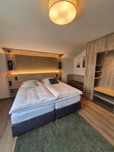 a bedroom with a large bed in a room at Hotel Restaurant Brinckwirth in Ochtrup