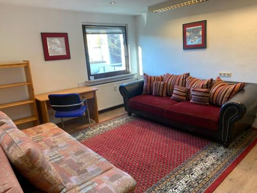 a living room with a red couch and a window at Business Apartment Herne-Wanne in Herne