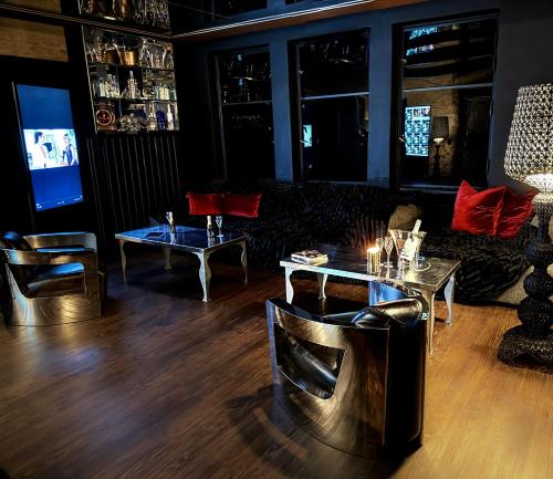 a living room with couches and tables and a television at Secret Labelle Époque Hideaway in Berlin