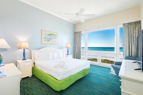 a bedroom with a bed with a view of the ocean at Landmark Holiday Beach in Panama City Beach