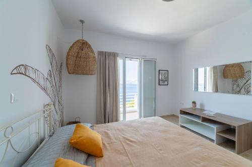 a bedroom with a bed and a desk and a window at AQUA KALMA in Myrties
