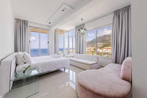 a bedroom with a bed and a large window at Villa Belle Azure by PikHost in Dhërmi