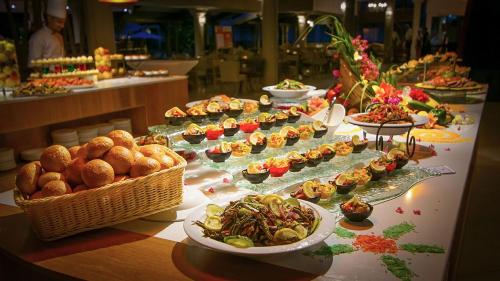 a buffet with many different types of food on a table at Le Peninsula Bay Beach Resort & Spa in Blue Bay