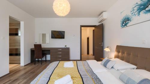 a bedroom with a bed and a desk in it at Vila LeDa by Villas Guide in Barban