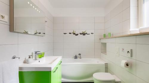 a white bathroom with a sink and a toilet at Vila LeDa by Villas Guide in Barban