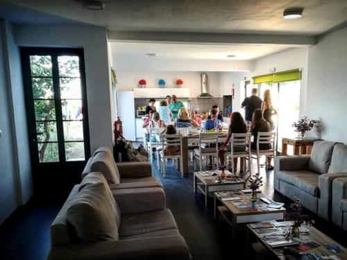 a living room with couches and a group of people at BELO CAMPO - Ilha do Faial (Horta) in Castelo Branco