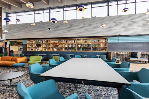 a cafeteria with a white table and blue chairs at For Students Only Space St Andrews in St. Andrews