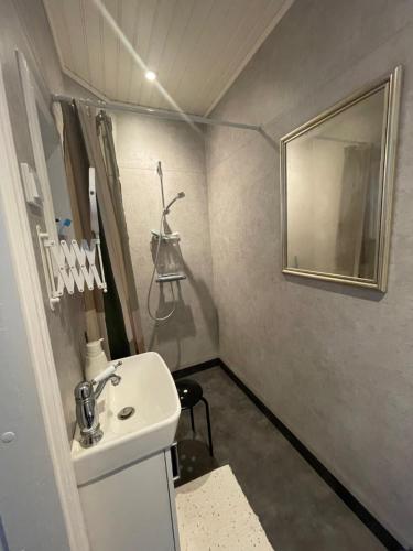 a small bathroom with a sink and a mirror at Granbo station in Granbo