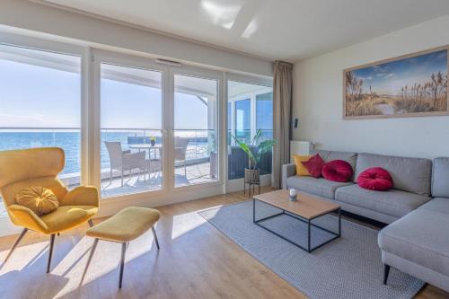 a living room with a view of the ocean at Ferienwohnung Seeloge im Bollwark Olpenitz in Olpenitz