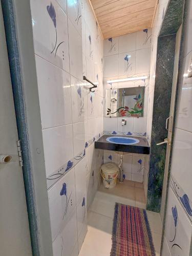 a small bathroom with a sink and a mirror at Hotel Kinara Lodge in Jāmkhed
