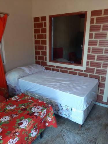 two beds sitting in a room with a window at Hospedaje Margarita in Encarnación