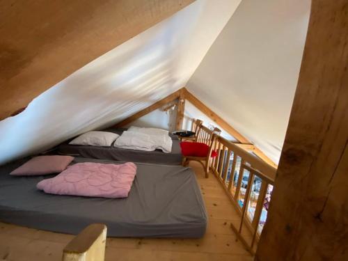 a room with two beds in a attic at Loft des Cimes - Evasion en montagne avec local vélo privé in Cornimont