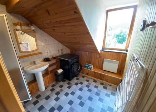 a small bathroom with a sink and a stove at Loft des Cimes - Evasion en montagne avec local vélo privé in Cornimont