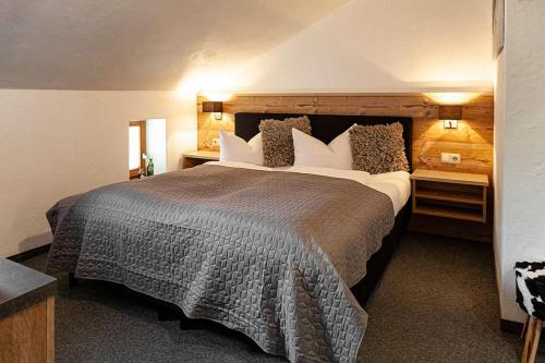 a bedroom with a large bed in a hotel room at Berghotel TheLounge in Berwang