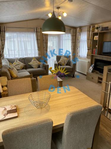 a living room with a table and a couch at Hikers Den, Brigham, Cockermouth, Cumbria in Cockermouth