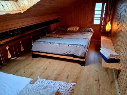 a bedroom with a bed and a table in a cabin at Lake view Chalet , Drligen in Därligen