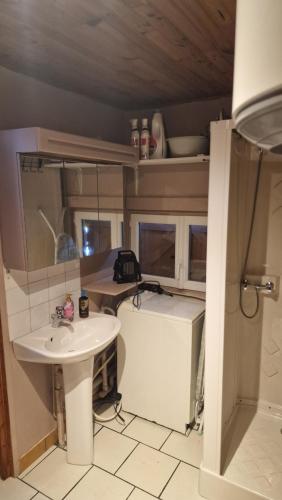 a bathroom with a sink and a tub and a sink at Chalet in Saint-Anthème