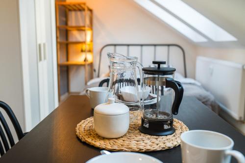 a table with a coffee maker and cups on it at V&D 7 by Mountain ways in Rokytnice nad Jizerou