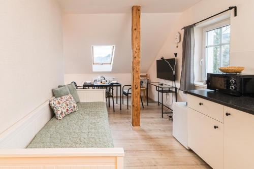 a kitchen and living room with a couch and a table at V&D 7 by Mountain ways in Rokytnice nad Jizerou