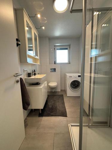a bathroom with a sink and a washing machine at Gemütliche Wohnung in Puch in Puch bei Hallein