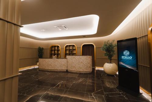 a lobby with a smiley sign on the wall at Stillo Business Hotel & Spa in Aliağa