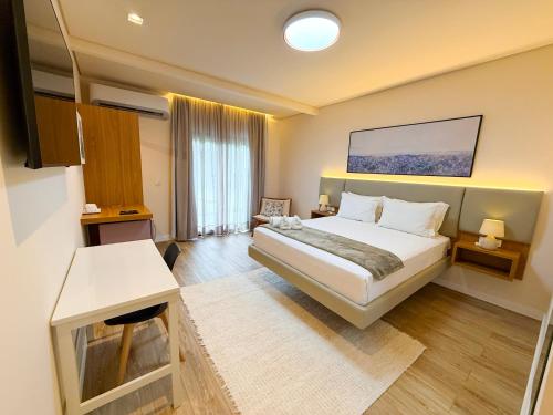 a hotel room with a bed and a table and a desk at Pousada Girassol in Bonito